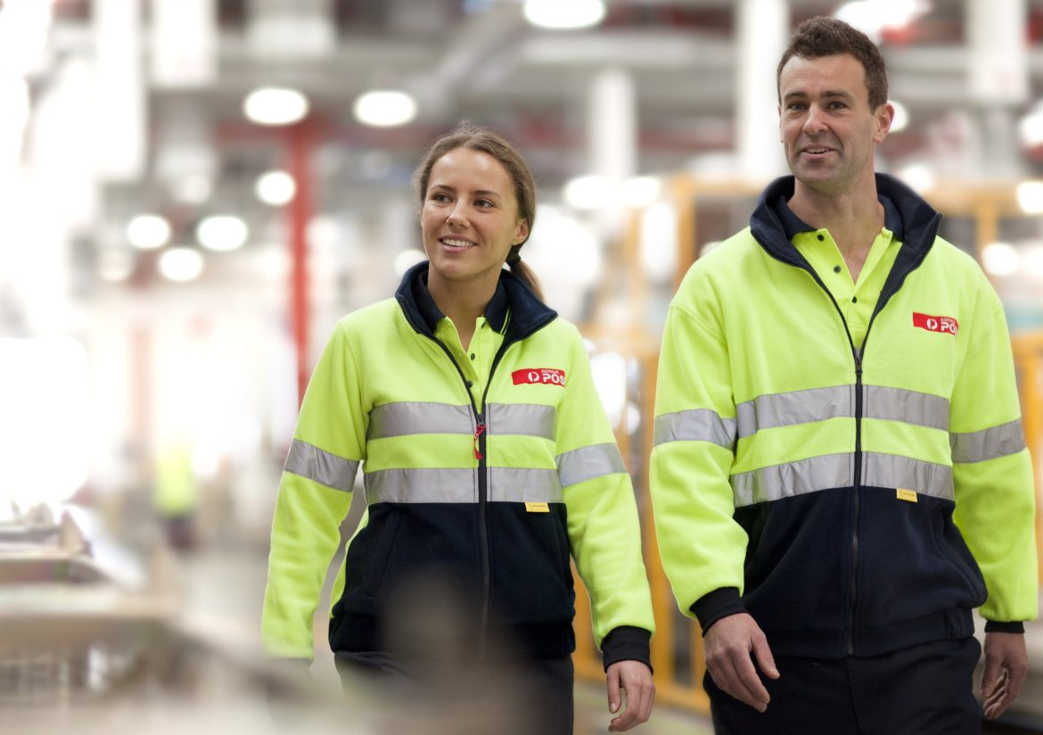 Two Australia Post workers walking.