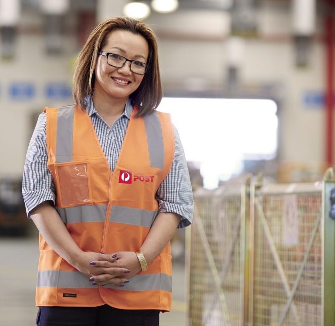 Woman in an Australia Post vest.